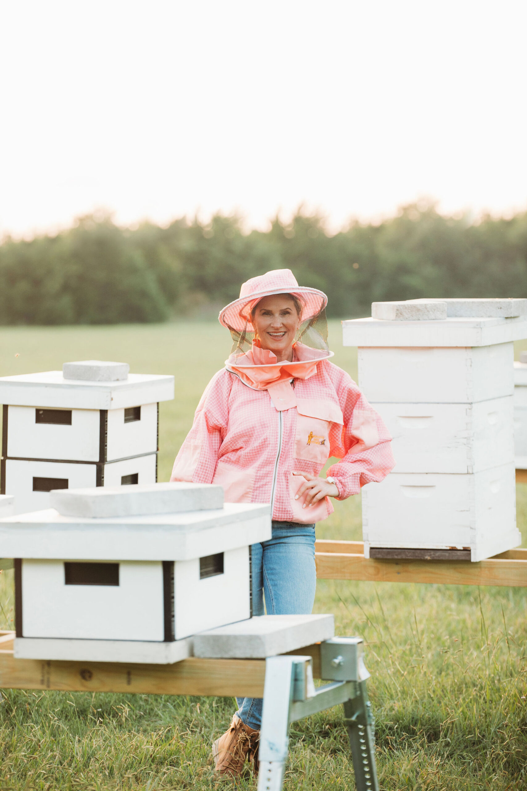 Esther, co-founder of Unchaperoned Life, with her beehives